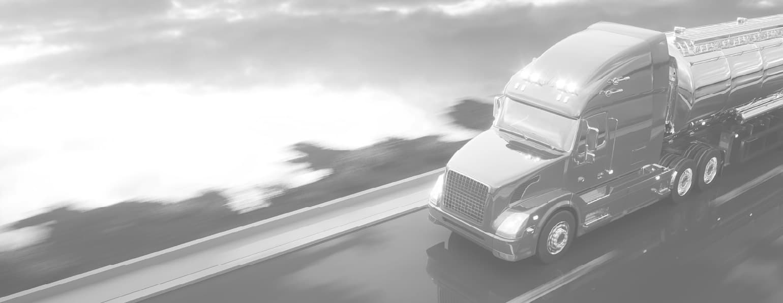 Fuel tanker truck on highway at sunset
